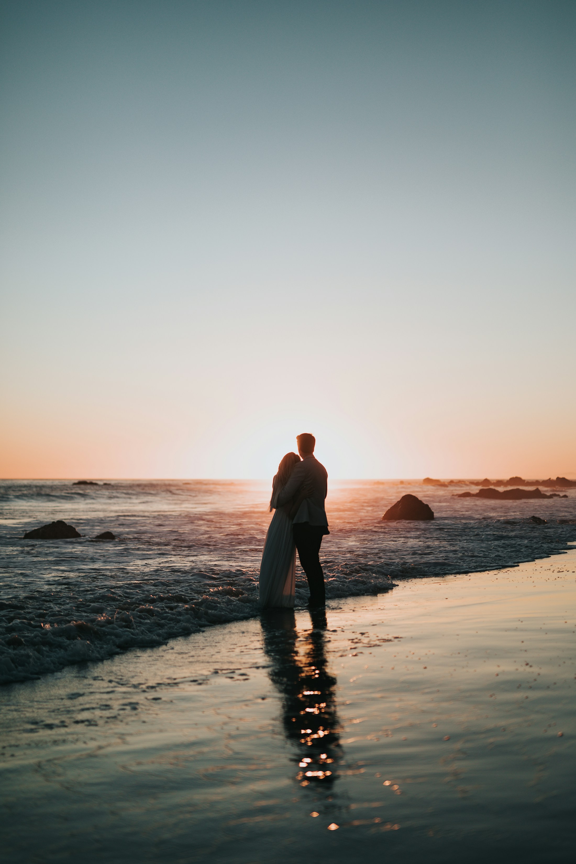 Silhouetted couple on the beach